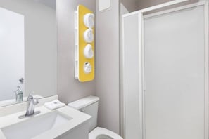 A bathroom with a white sink, a mirror, a toilet, and a shower. - 1 Queen Bed | Micfridge | Non-smoking (Woodland)