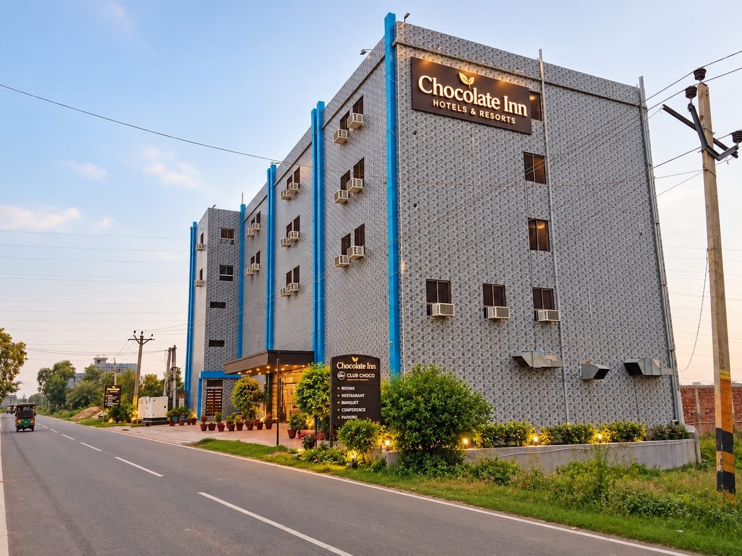 A multi-story building with a sign reading 'Chocolate Inn Hotels & Resorts.'