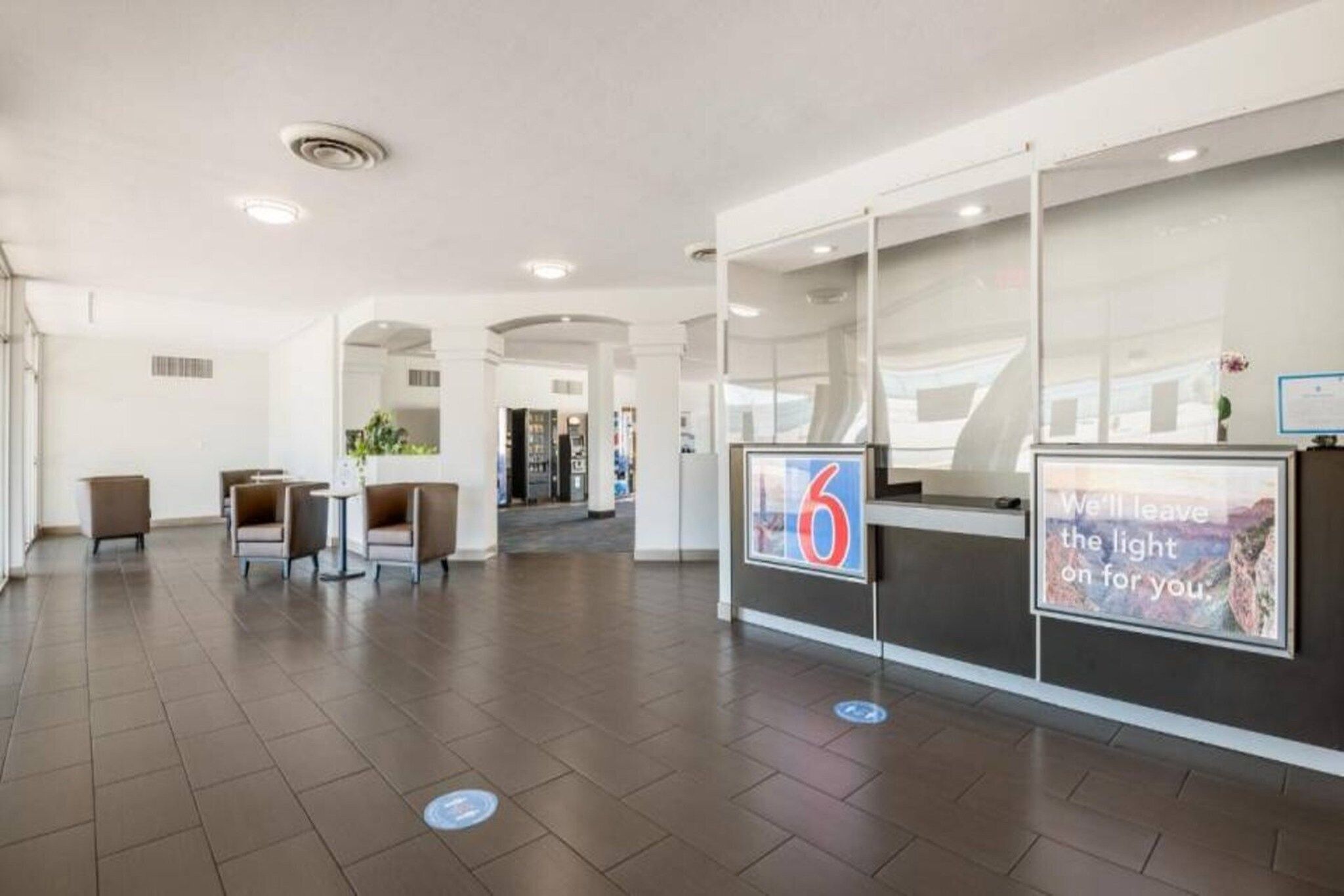 A spacious lobby with a reception desk, seating area, and a view of the interior.