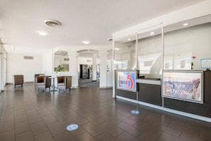 A spacious lobby with a reception desk, seating area, and a view of the interior. - 1 King Bed | Non-Smoking, Mini Fridge (Tucson AZ)