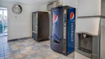 A vending area with Pepsi machines and a refrigerator.