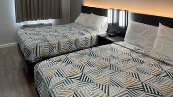 Two twin beds with patterned bedding in a hotel room.