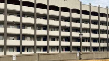 A multi-story parking garage with a uniform architectural style, featuring balconies on each floor.
