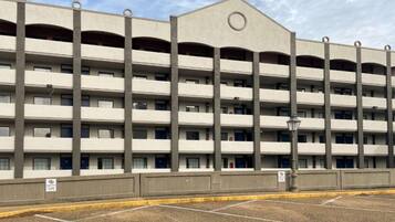 A multi-story parking garage with a flat roof and a central circular feature.