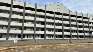 A multi-story parking garage with a flat roof and a series of balconies on each floor.