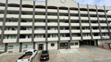A multi-story parking garage with a flat roof and a central entrance.