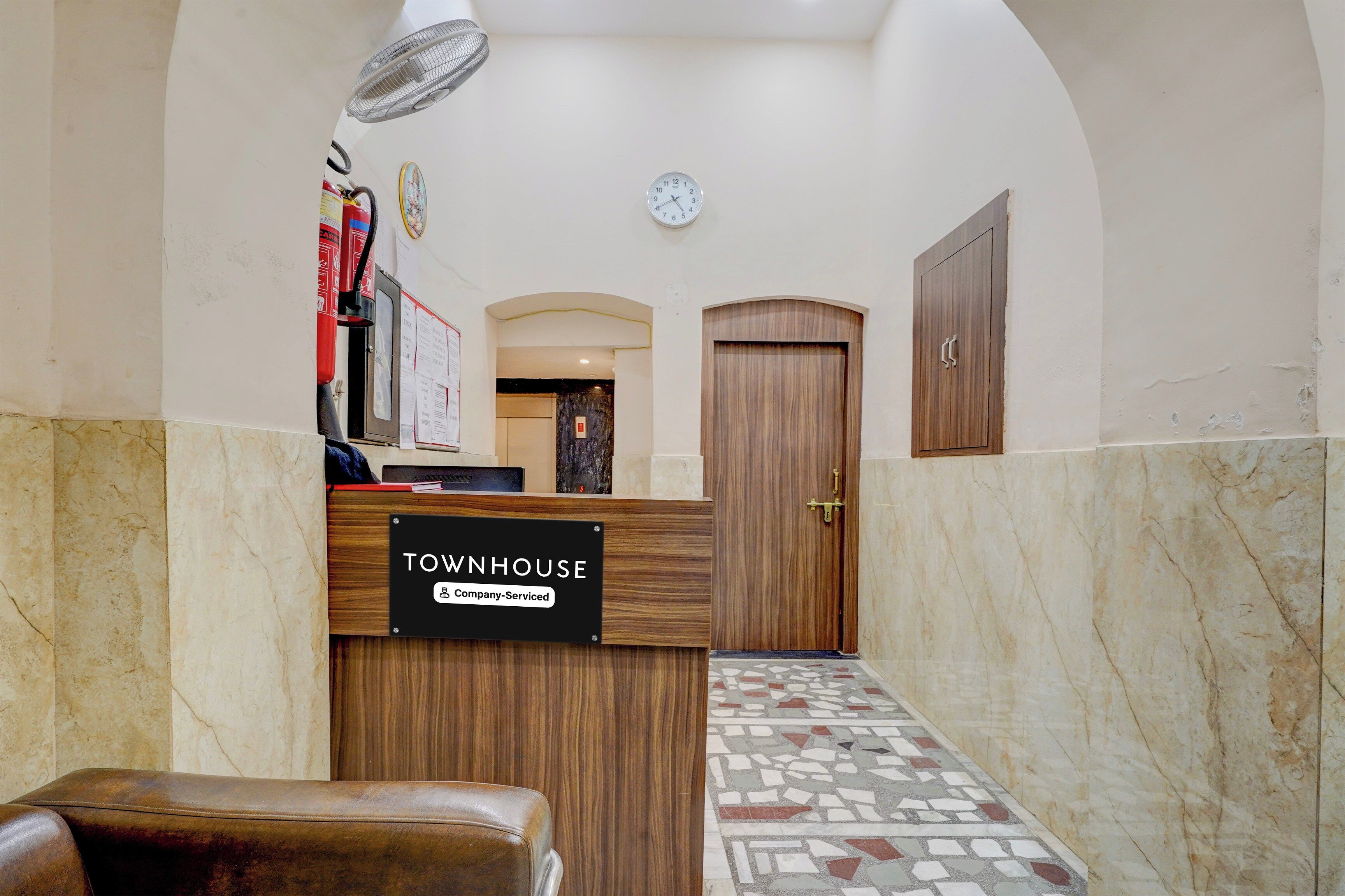 A reception area with a sign reading 'TOWNHOUSE' and a reception desk.