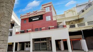 A multi-story building with a sign indicating it is a company-serviced townhouse.