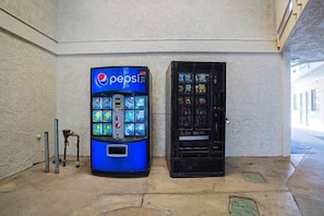 Una màquina expenedora de Pepsi i una vitrina de vidre amb articles de colors.