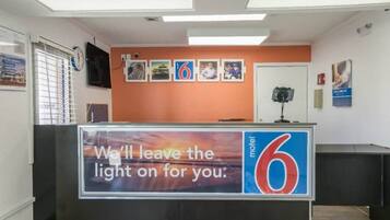 A hotel reception desk with a sign indicating the name 'motel 6'.