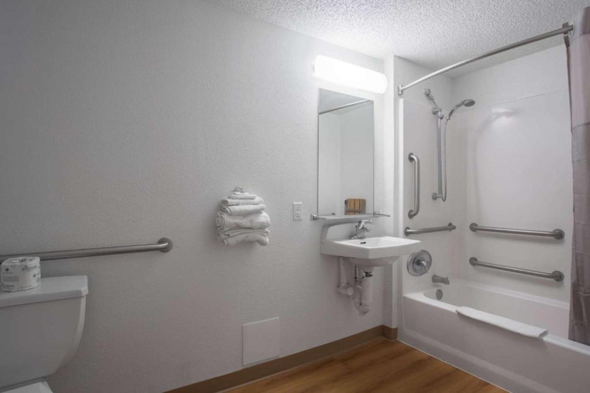 A bathroom with a toilet, sink, and shower.