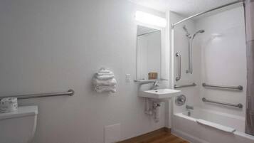 A bathroom with a toilet, sink, and shower.