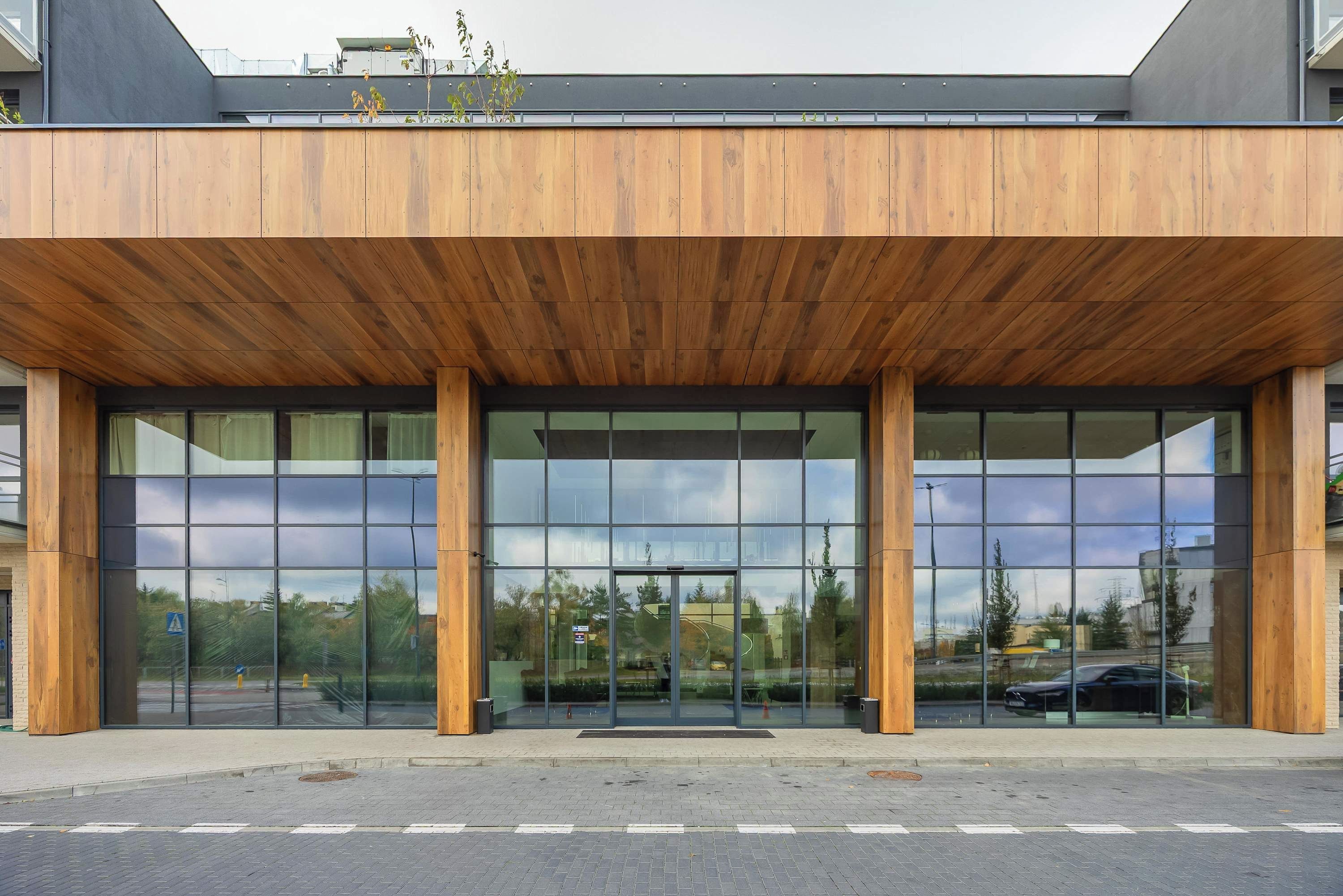 A modern building with a wooden facade and large glass entrance.