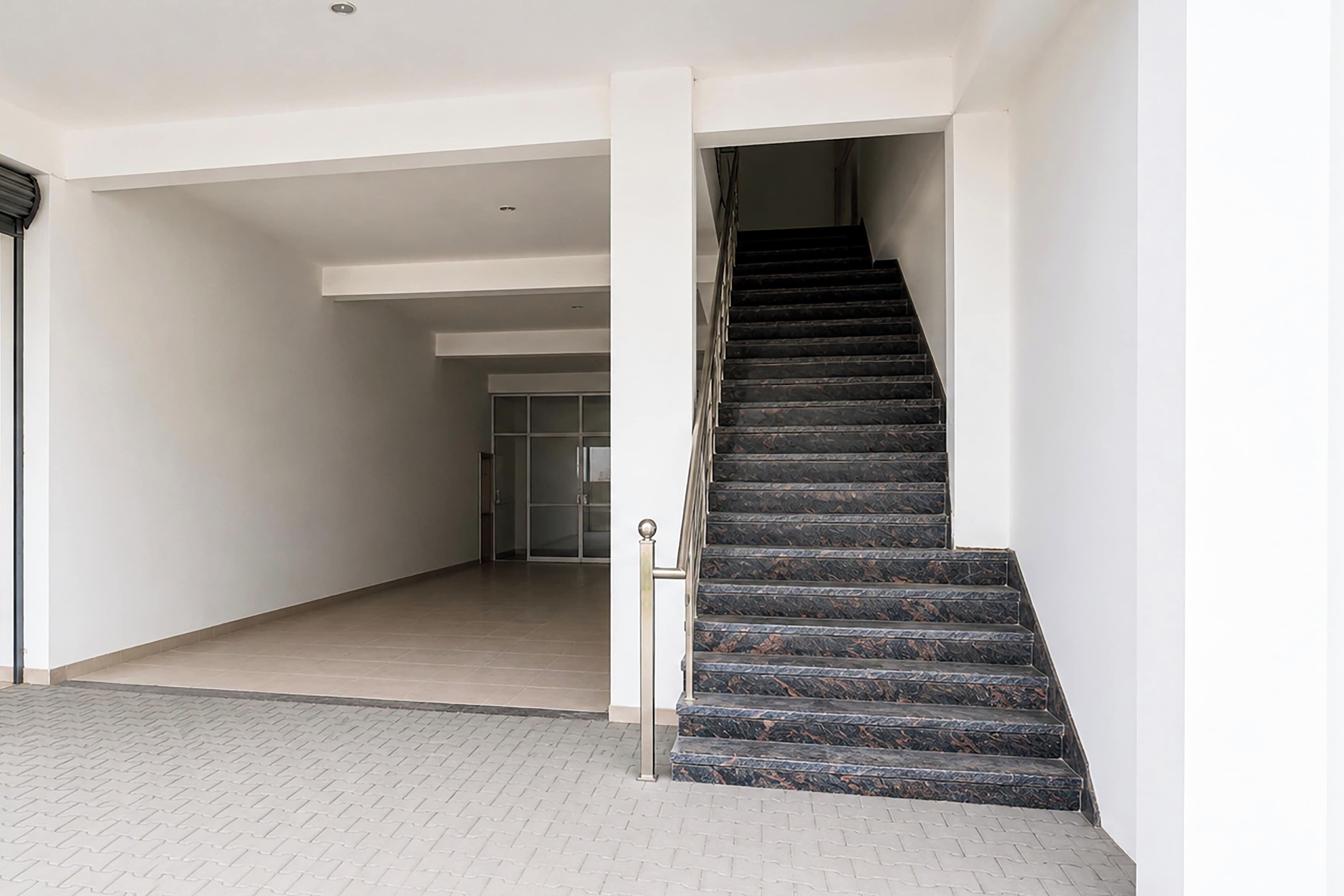 A staircase with a handrail leading to an upper floor.