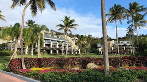 Ein Resort mit mehrstöckigen Gebäuden, Palmen und liebevoll angelegten Gärten.