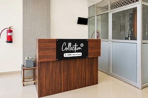 A reception desk with a sign that reads 'Collection OYO-Serviced.' - Hotel O Munsi Puliya Metro Lucknow (Lucknow)