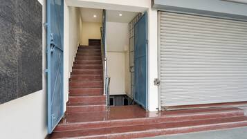 A staircase leading to a room with a closed garage door.