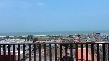 A coastal cityscape with buildings and a clear view of the sea.