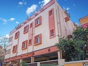 A multi-story building with a flat facade, multiple windows, and a visible entrance.