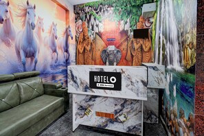 A hotel reception desk with a marble top and a sign indicating it is an 'OVO-Serviced' hotel. - Hotel O Venkateswara Swamy Temple (Hyderabad)