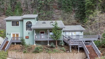 A two-story house with a front porch and a small attached garage.