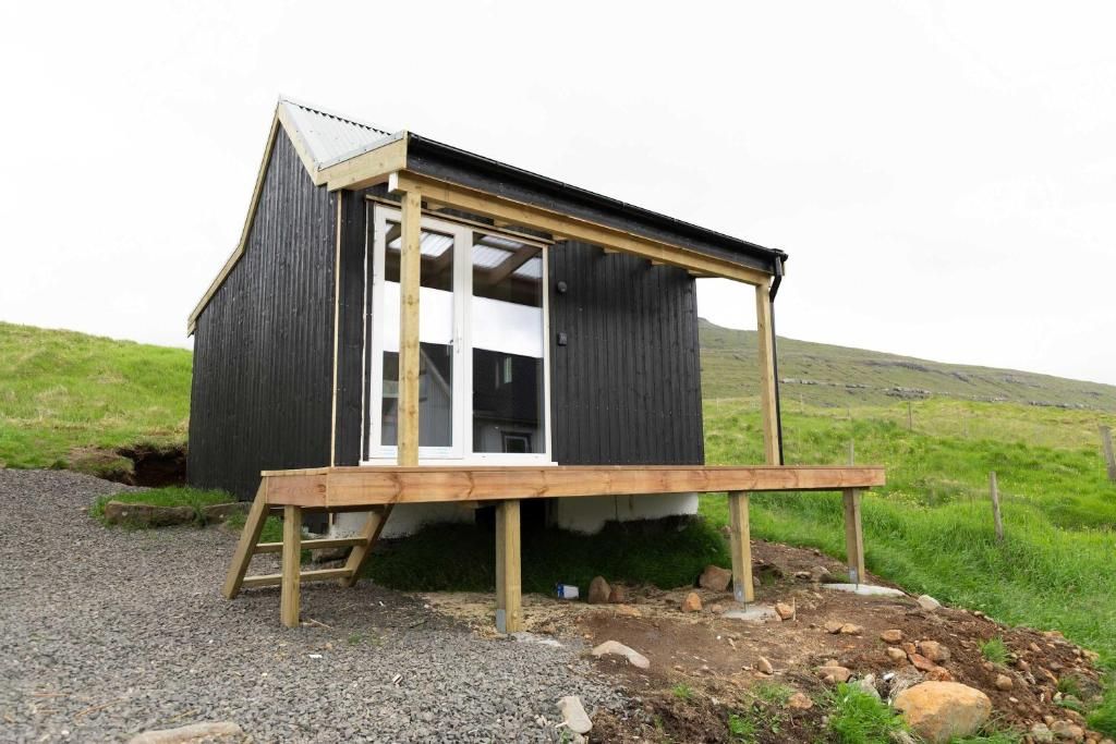 A small wooden structure with a slanted roof and a single visible window.