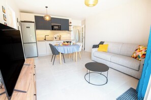 Eine moderne Küche mit Essbereich, einer Couch und einem Couchtisch.