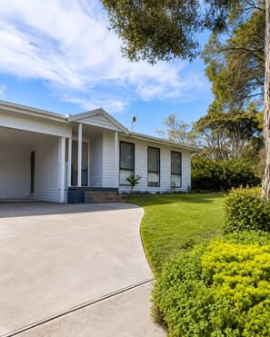 A single-story house with a covered porch, a driveway, and a well-maintained lawn. - Best of Both Beaches in Blairgowrie (Mornington Peninsula Shire)
