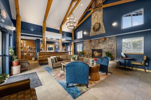 A spacious lobby with a stone fireplace, seating area, and a reception desk. - 1 mile to Rocky Mountain NP – 2BR Pool, Hot Tub (Estes Park)