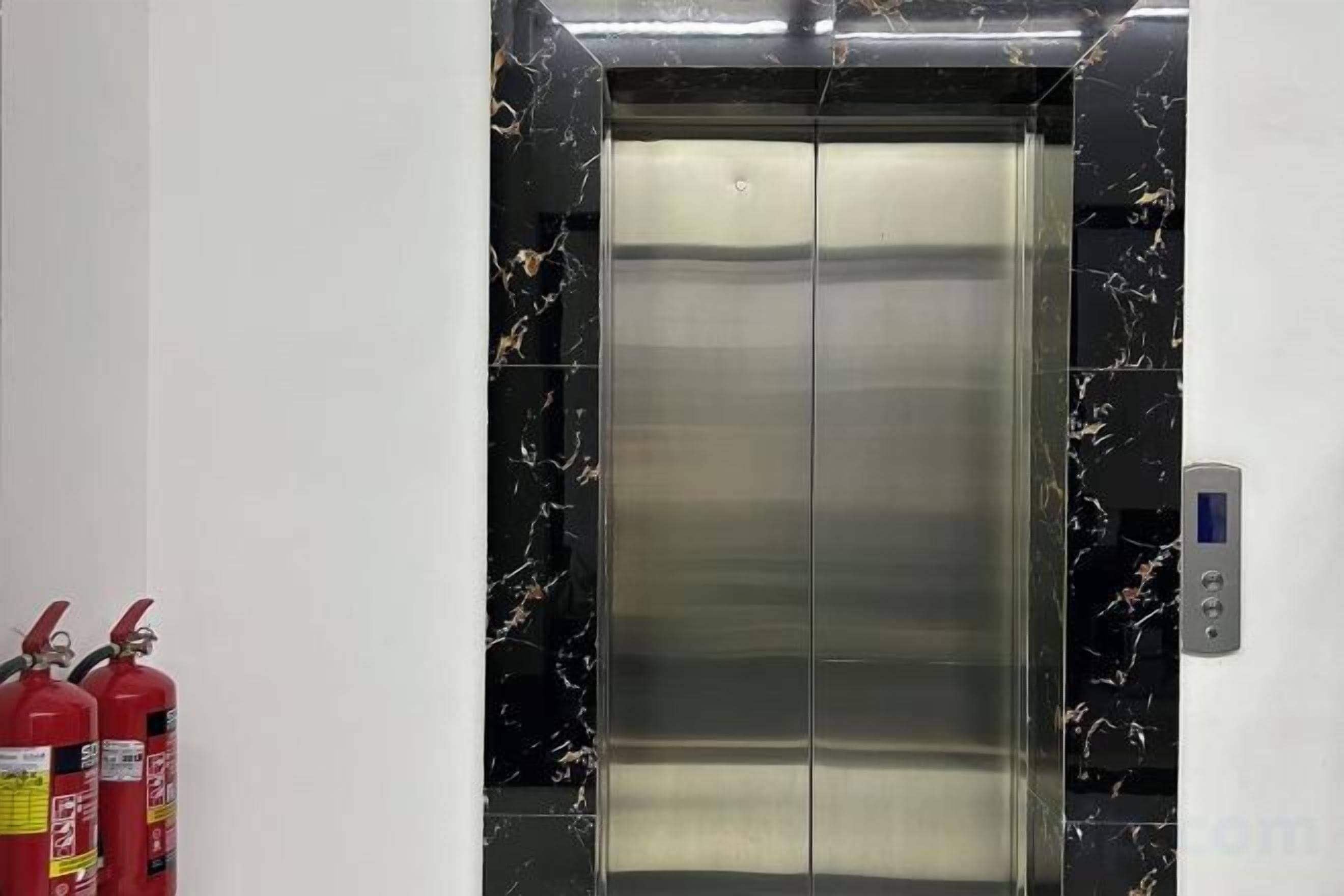 An elevator with a control panel on the right side.
