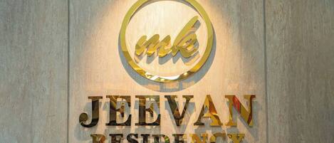 A sign with the text 'JEEVAN RESIDENCY' and a logo above it.
