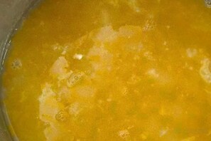A close-up of a yellow liquid with bubbles, possibly a beverage or a chemical reaction. - Sijixinghe Hotel (Dushanbe)