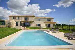 A two-story house with a swimming pool, outdoor seating, and a stone feature. - Holiday home with 5 bedrooms (Bagnols sur Cèze)