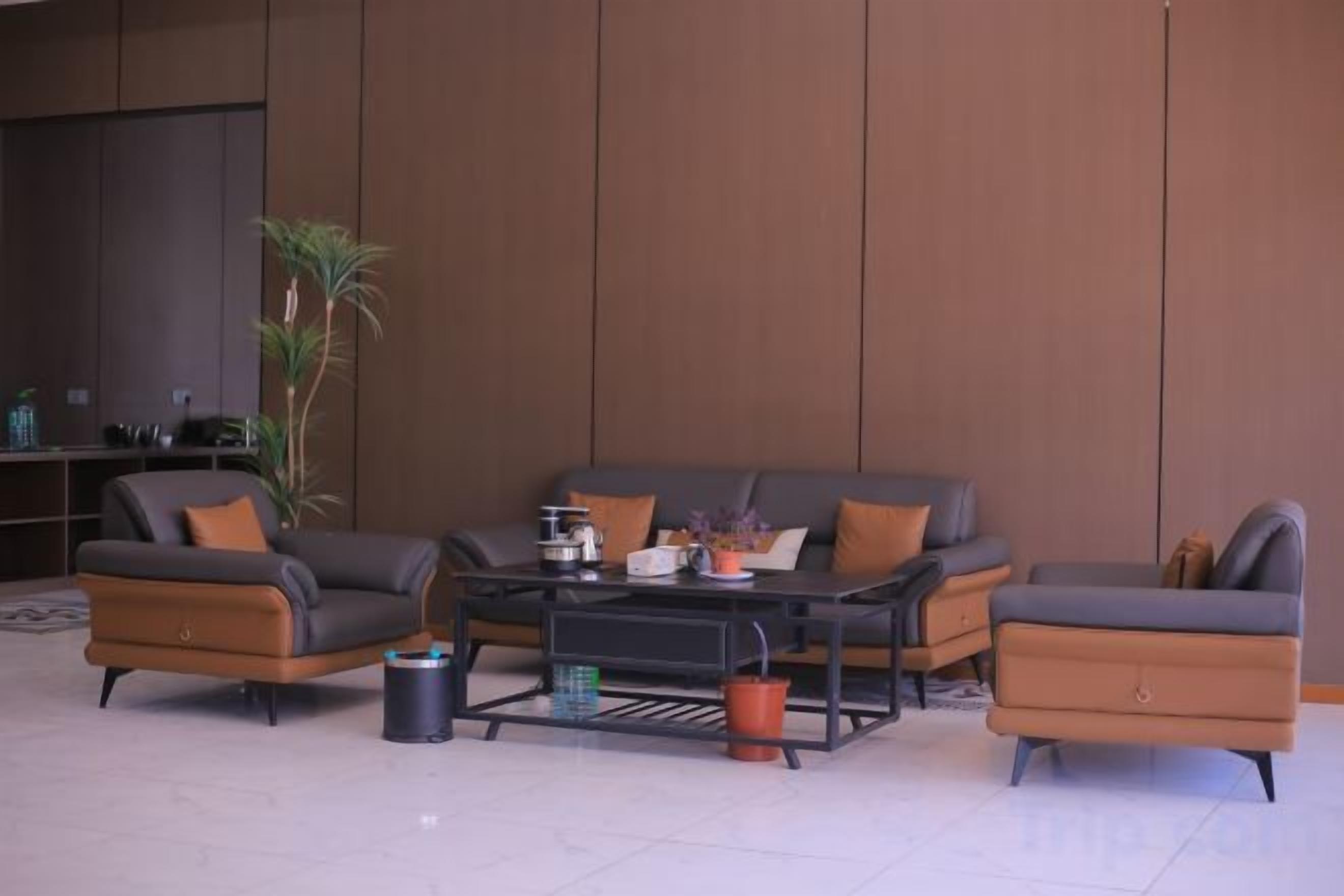 Un salon moderne avec un canapé d’angle, une table basse et un téléviseur.