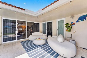A modern living room with a sectional sofa, a coffee table, and a potted plant. - Sun, Pool & Sand- Fort Lauderdale Style Escape! (Fort Lauderdale)