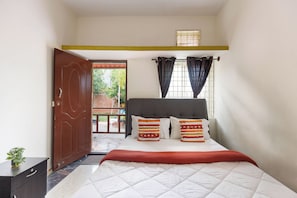A bedroom with a bed, a wardrobe, a window with curtains, and a door leading outside. - White Swan by Stayjadepoolbbqbonfire Mysore Rd (Ramanagara)