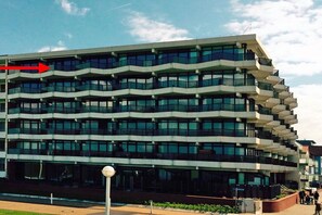 A multi-story building with a modern architectural design, featuring balconies and large windows. - Holiday apartment with 1 bedroom (Norderney)