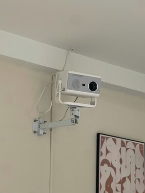 A projector mounted on a wall with a cable connected to it. - Hanoi Aurelia Residence (Hanoi)
