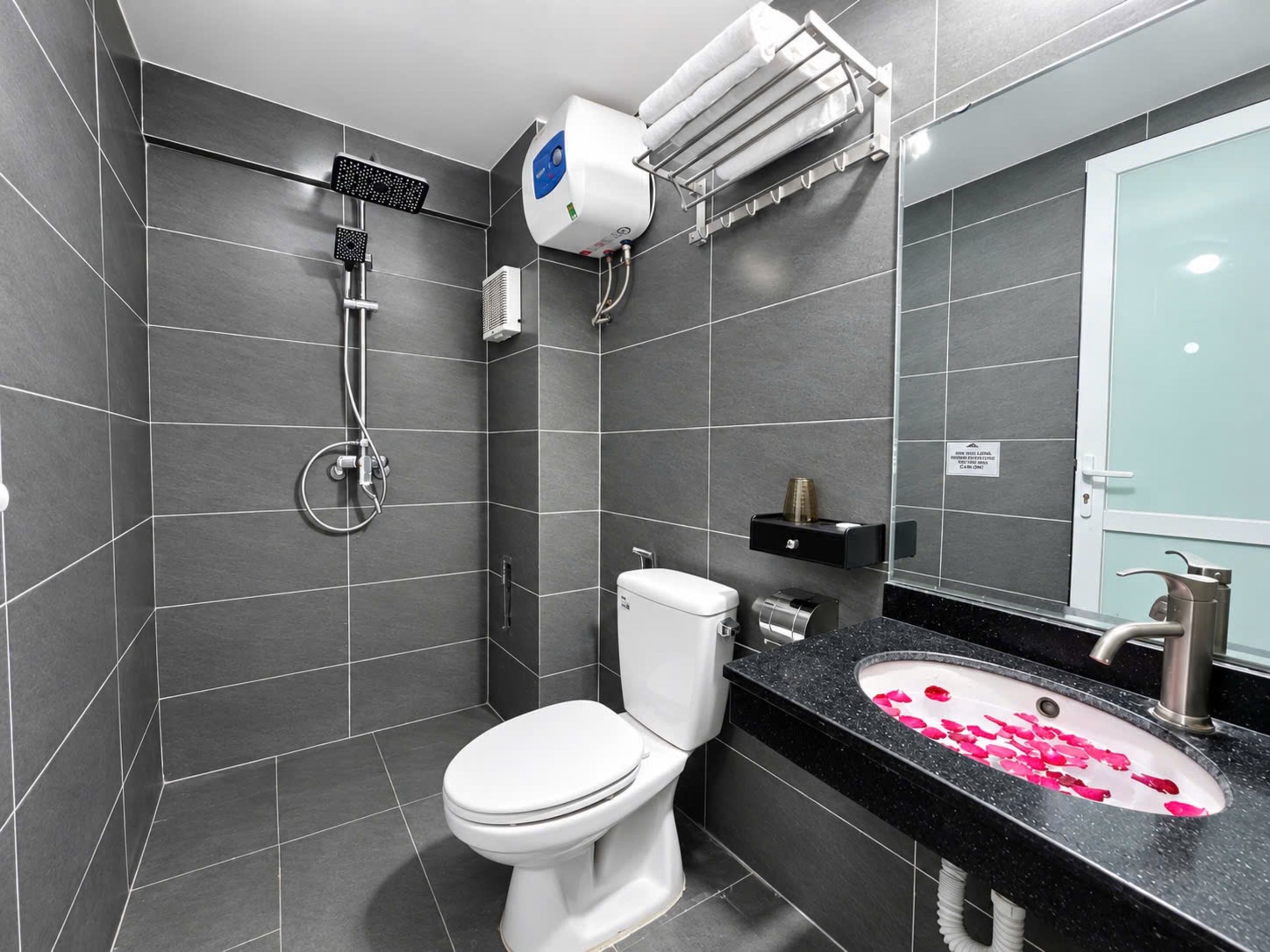 Une salle de bain moderne équipée de toilettes, d’une douche et d’un lavabo.