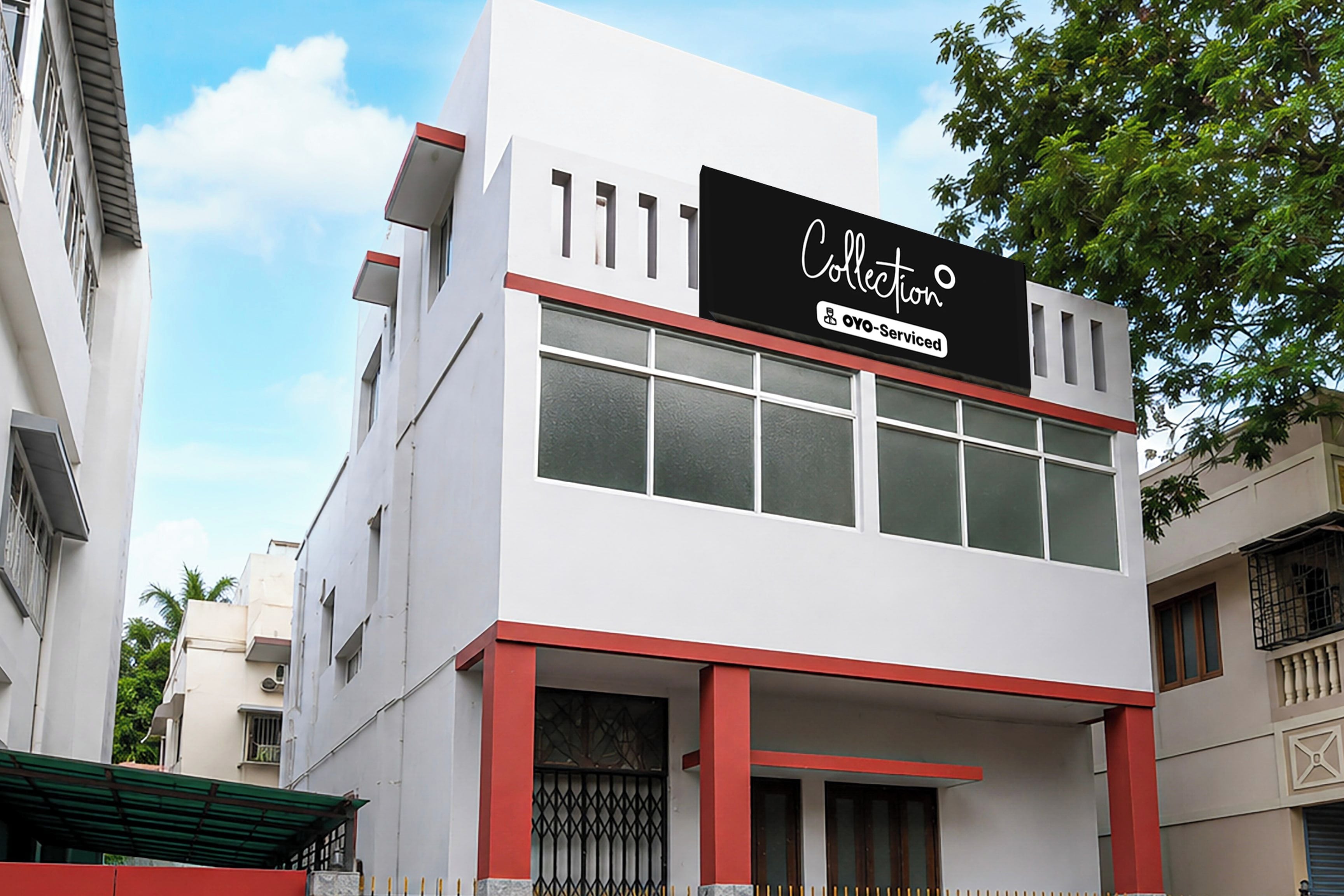 A modern building with a sign indicating it is serviced by Oyo.