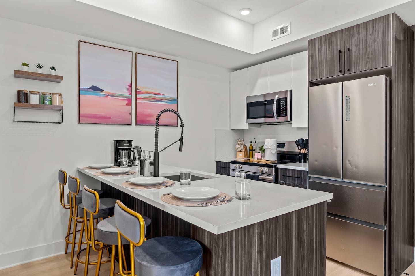 A modern kitchen with a central island, stainless steel appliances, and a minimalist design.
