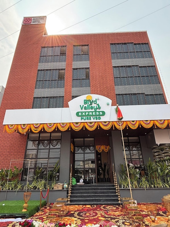 A building with a sign for 'BIRD Valley Express Pure Veg' and a traditional entrance with steps and a railing. - Mastiff Hotel, Hinjawadi (Paud)