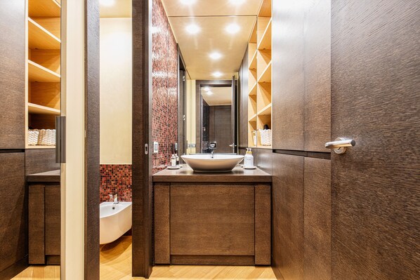 A modern bathroom with a large sink, mirror, and wooden cabinets. - Be My Guest Verona - Heart of the Old Town - Bright, Spacious & Quiet Apartment (Verona)