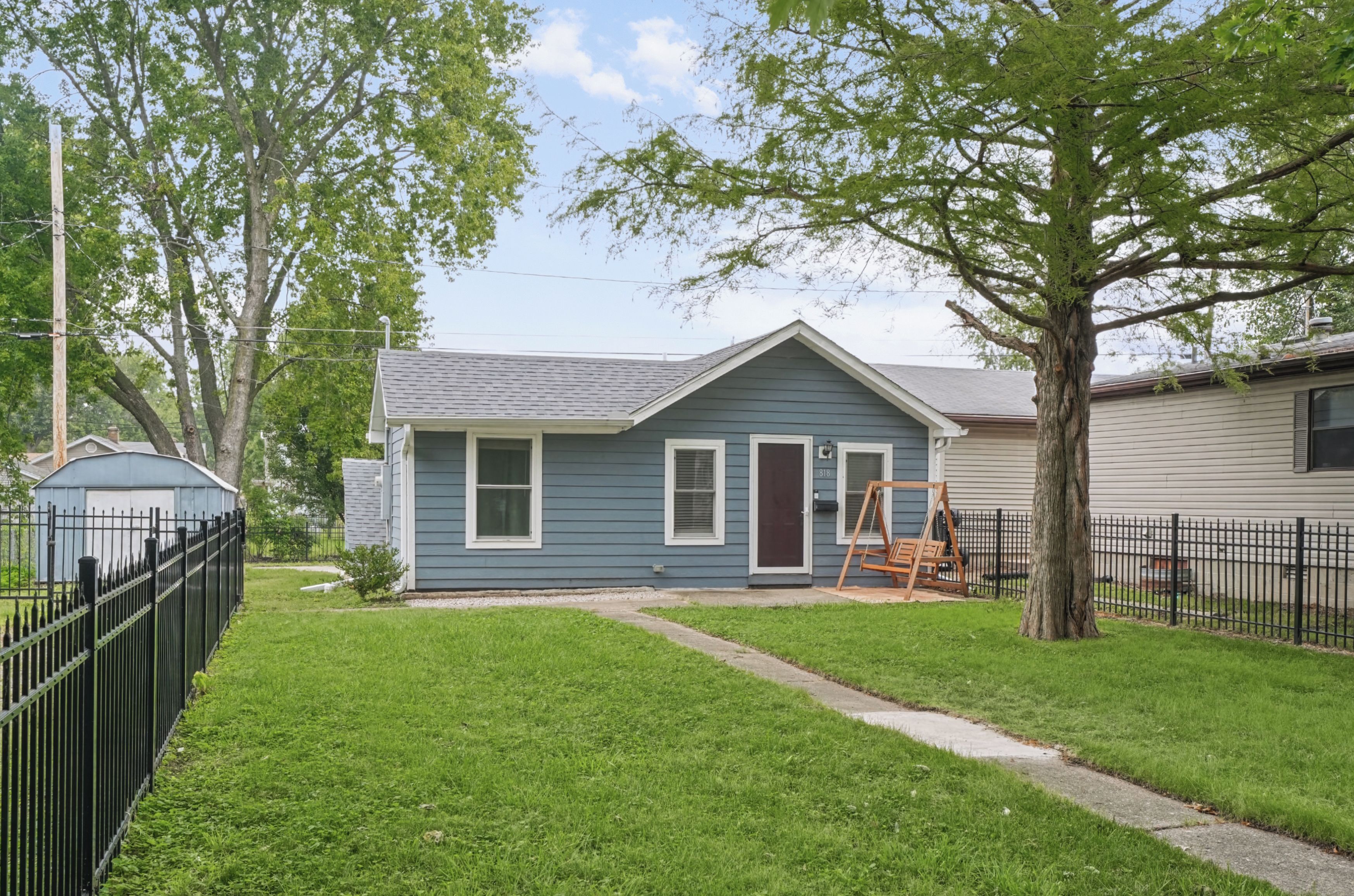 A classic blue-gray exterior and inviting porch set the tone for a relaxing stay.
