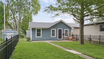 A classic blue-gray exterior and inviting porch set the tone for a relaxing stay.