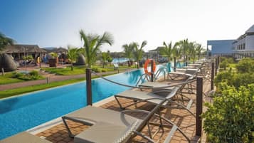 A poolside area with lounge chairs, a lifebuoy, and a clear view of the pool.