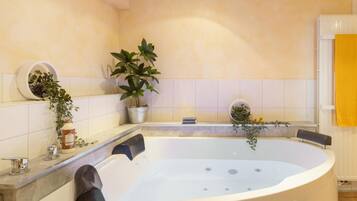 A modern bathroom with a freestanding bathtub, a potted plant, and a yellow towel on the right.