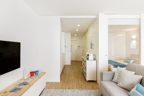 A modern apartment with a living room, kitchenette, and a bedroom. - Apartment 'Light Filled' with Terrace (Porto)