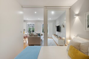 A modern bedroom with a bed, a desk, and a sofa. - Apartment 'Almada Prime with Balcony' (Porto)