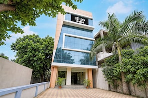 A modern hotel building with a sign that reads 'HOTEL' and 'OVO-Serviced'. - Hotel O Saibaba Temple Shirdi (Shirdi)